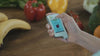 Person using NITERUS Greentest Food Safety Detector to check fruits for contaminants, nitrates, and radiation.